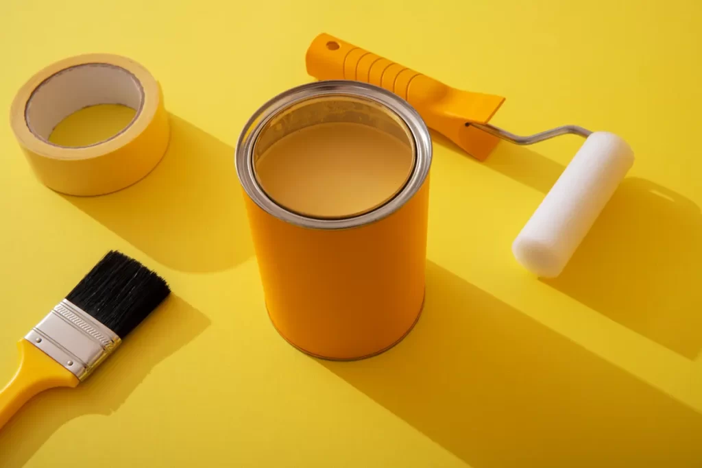 assortment painting items with yellow paint