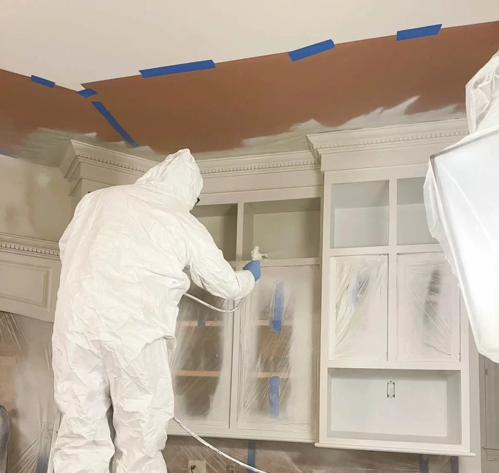 Spraying kitchen cabinets with Sherwin Williams Mindful Gray Paint 1 2 1